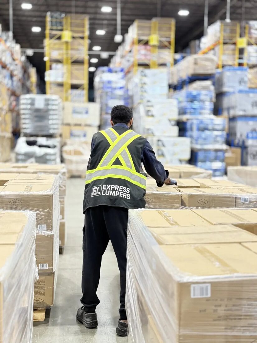 Express Lumpers associate preparing palletized freight in an Alberta warehouse