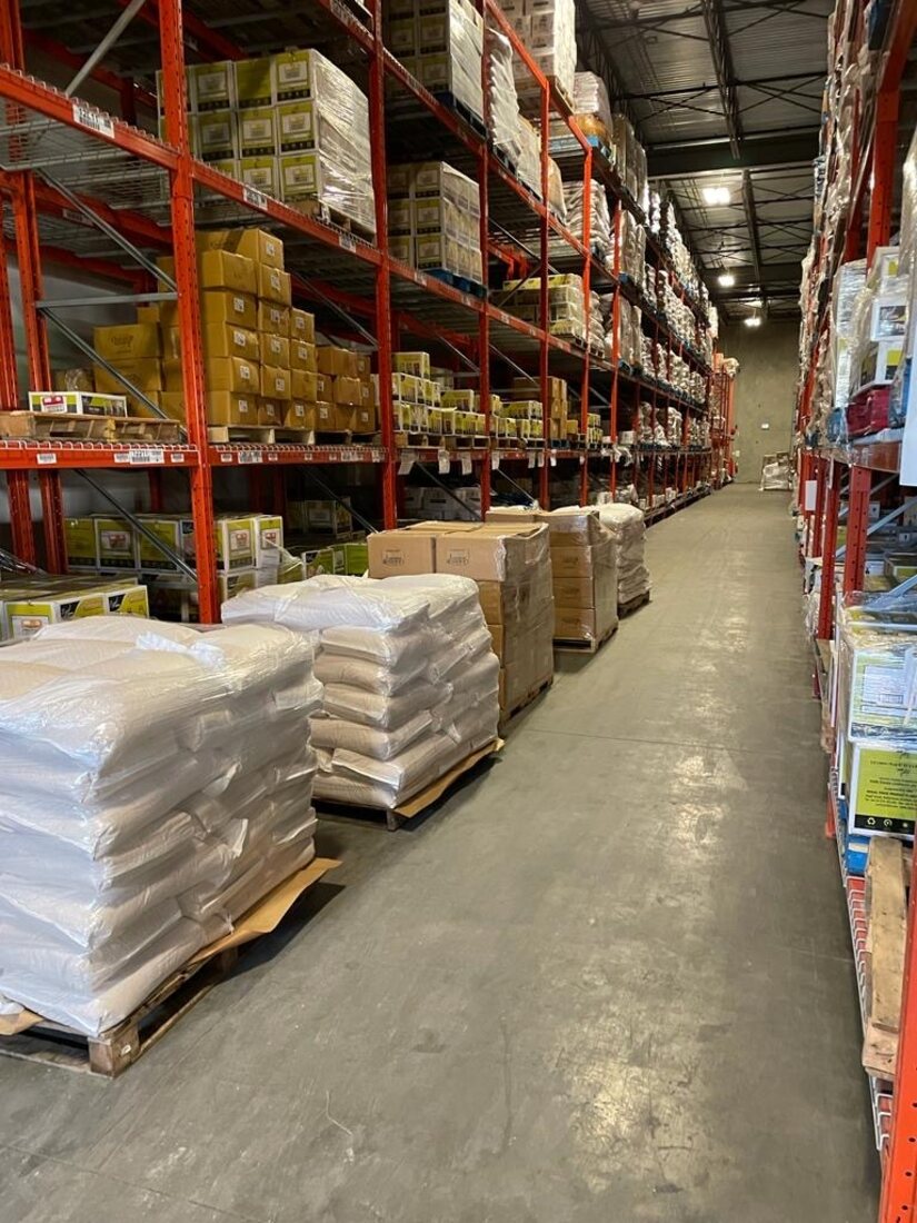 Palletized freight staged and organized for transfer in a Surrey warehouse aisle