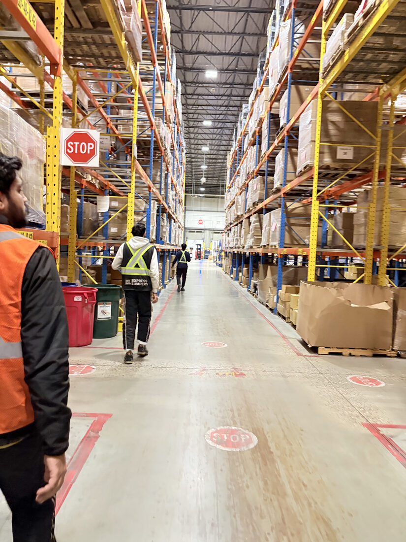 Express Lumpers crew moving through the warehouse aisles