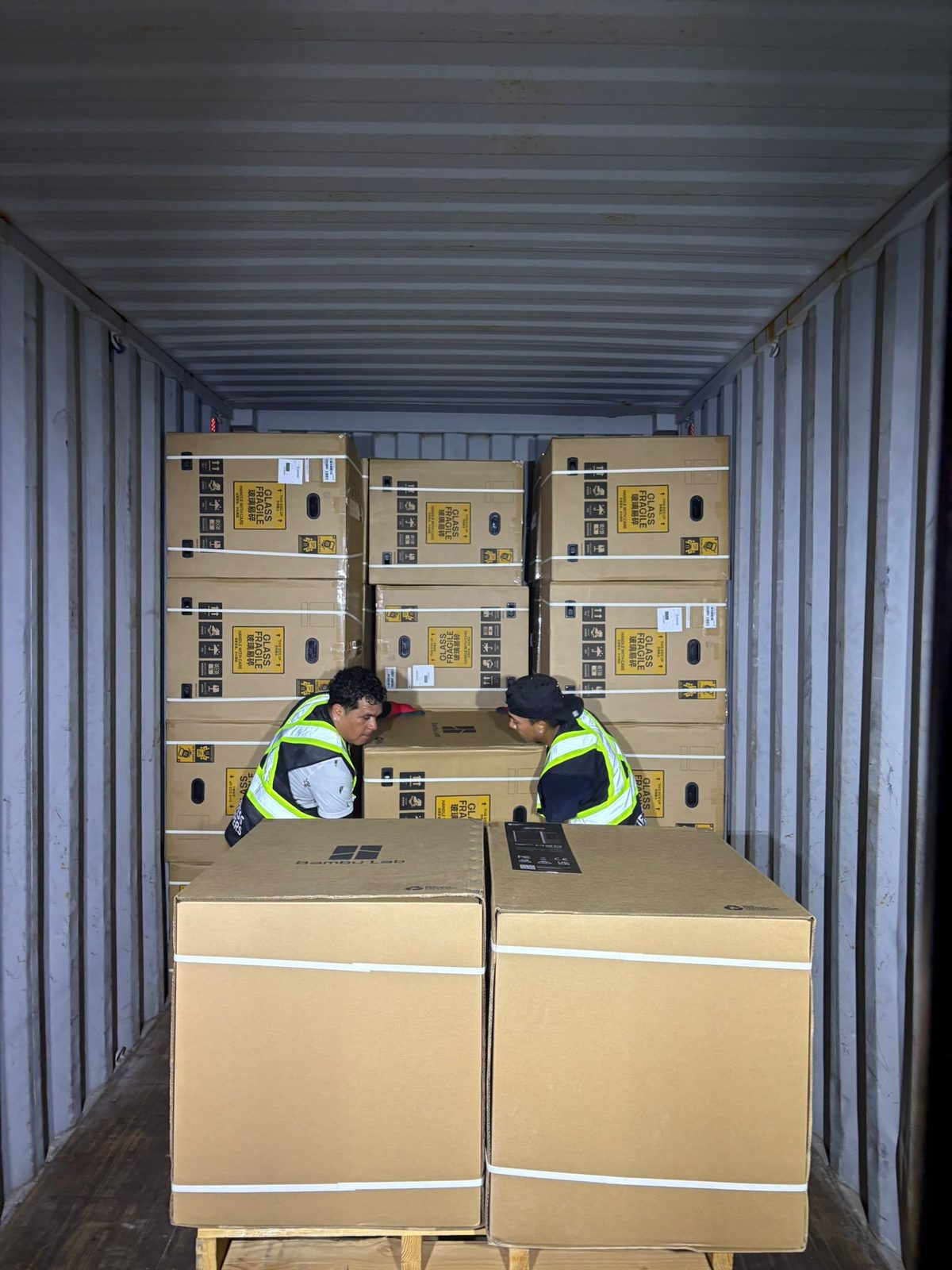 Express Lumpers crew unloading fragile freight inside a shipping container